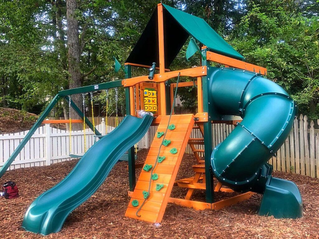 outdoor playhouse with climbing wall