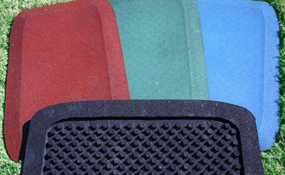 Residential playground safety mats in red, green, blue, and black