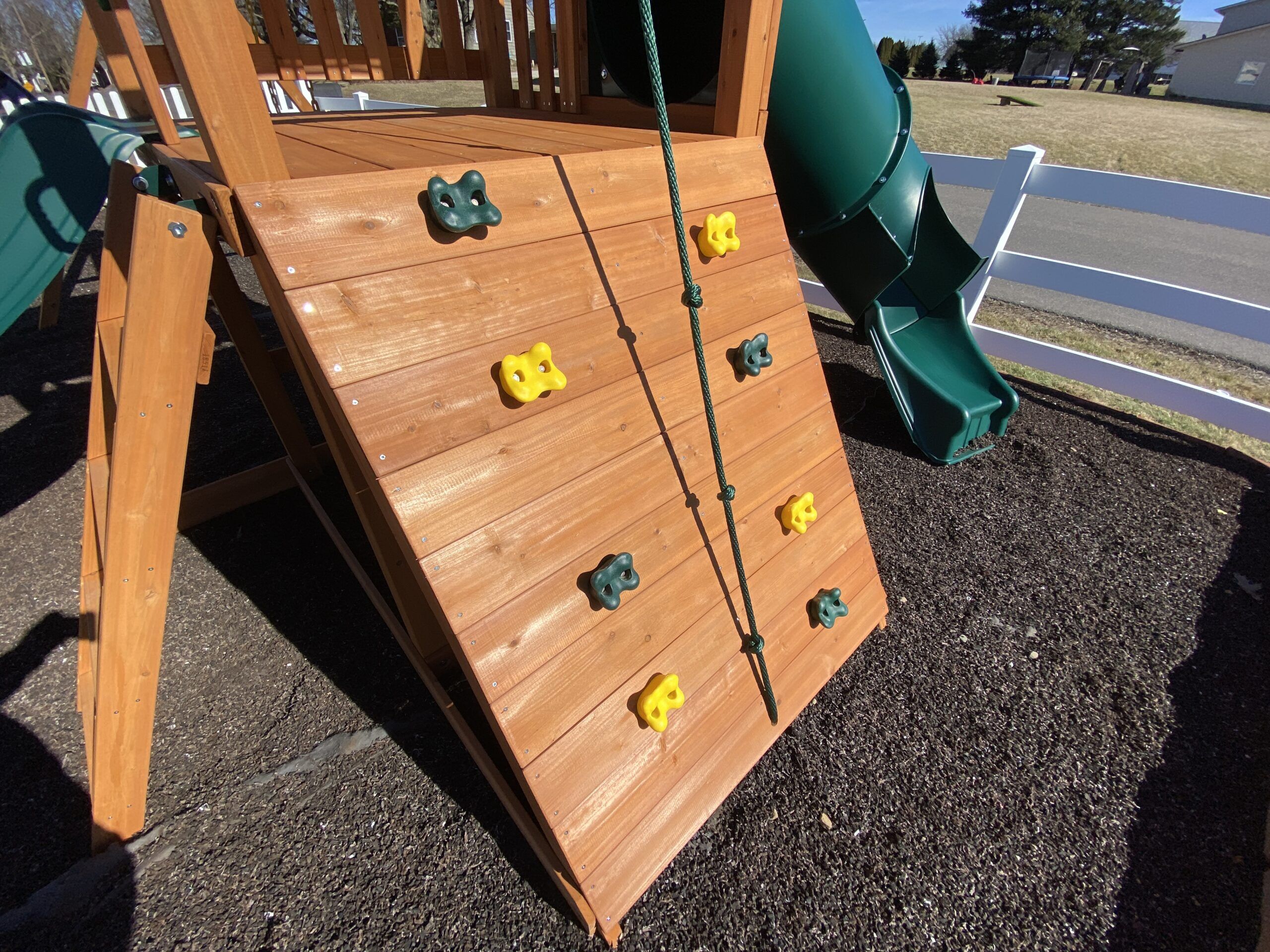 swing set with tube slide and rock climber