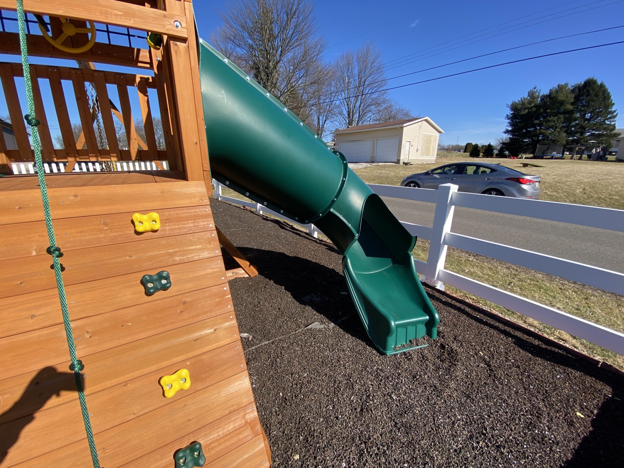 swing set with tube slide and rock climbers