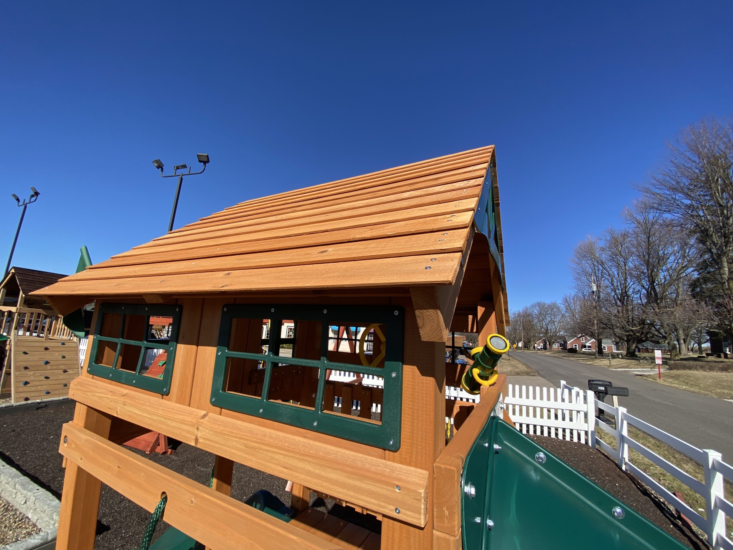 swing set with tube slide and wood roof