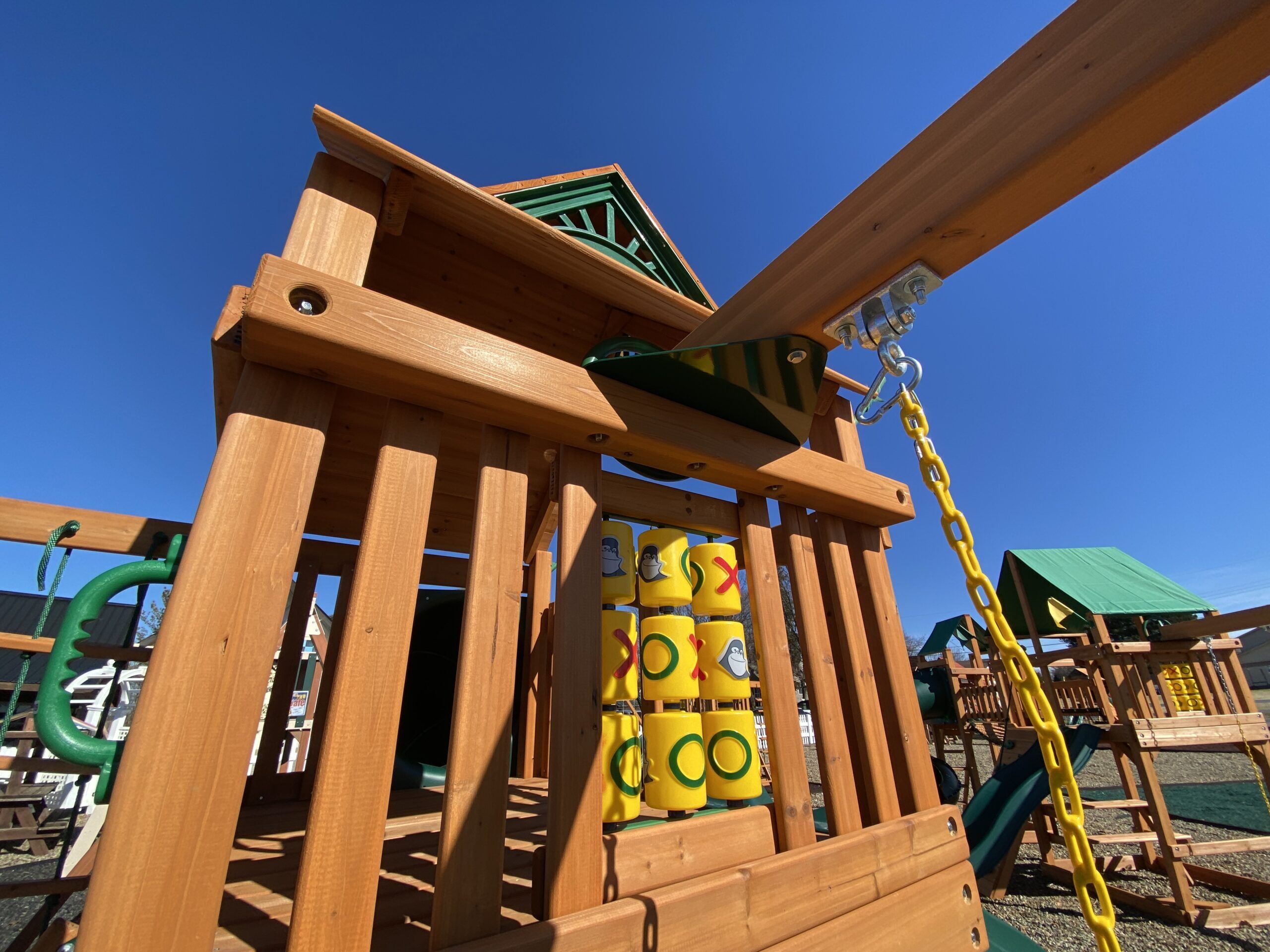 swing set with spiral slide and tic tac toe game
